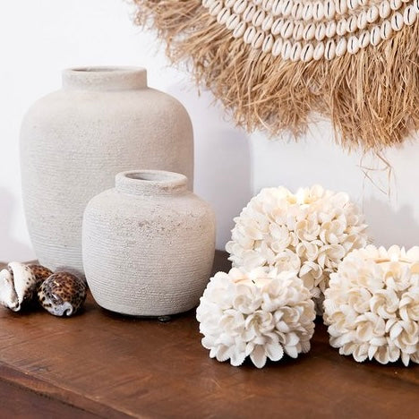 Waxinelichthouder versierd met witte schelpen in bloemvormig patroon, decoratief en natuurlijk design
